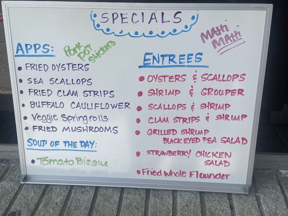 Printed menu pages with seafood plates and burgers.